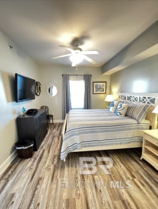 401 E Beach Blvd Unit 507, Gulf Shores, AL 36542 - bedroom with wood finished floors, baseboards, and a ceiling fan