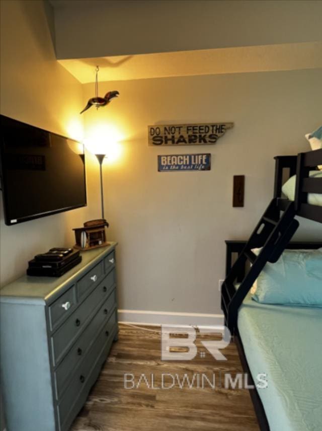 401 E Beach Blvd Unit 507, Gulf Shores, AL 36542 - bedroom with dark wood-type flooring and baseboards