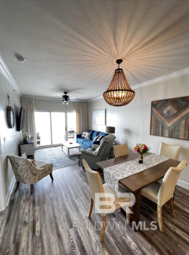 401 E Beach Blvd Unit 507, Gulf Shores, AL 36542 - dining area featuring crown molding, wood finished floors, and baseboards