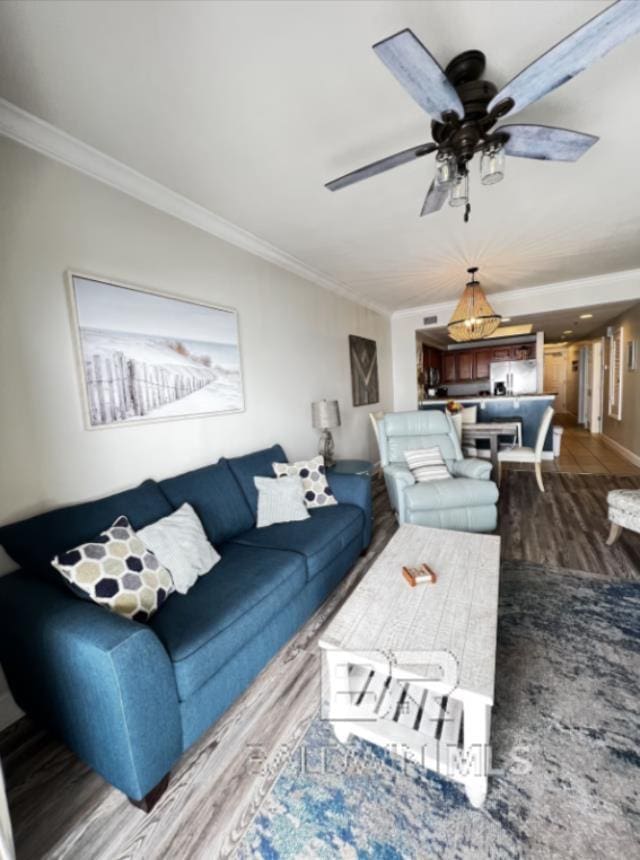 401 E Beach Blvd Unit 507, Gulf Shores, AL 36542 - living room with wood finished floors, crown molding, ceiling fan, and baseboards