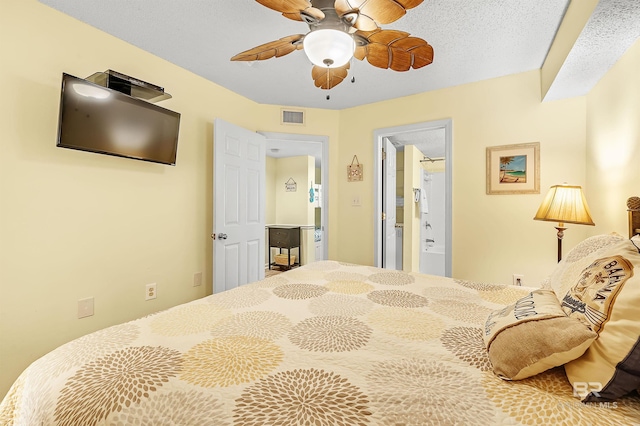 24114 Perdido Beach Blvd Unit 402, Orange Beach, AL 36561 - bedroom featuring connected bathroom, a textured ceiling, and ceiling fan