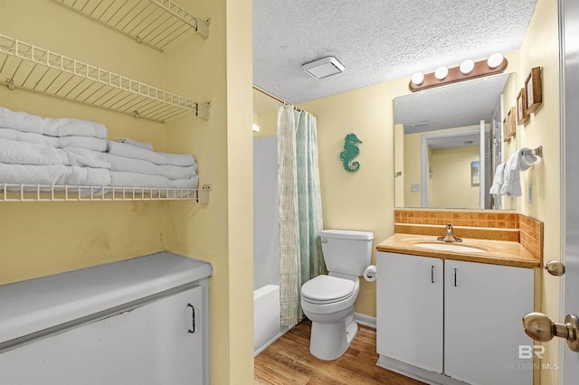 24114 Perdido Beach Blvd Unit 402, Orange Beach, AL 36561 - full bathroom featuring wood-type flooring, shower / bath combination with curtain, vanity, toilet, and a textured ceiling