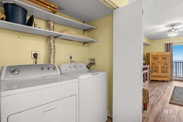 24114 Perdido Beach Blvd Unit 402, Orange Beach, AL 36561 - washroom with ceiling fan, washer and clothes dryer, a textured ceiling, and light wood-type flooring