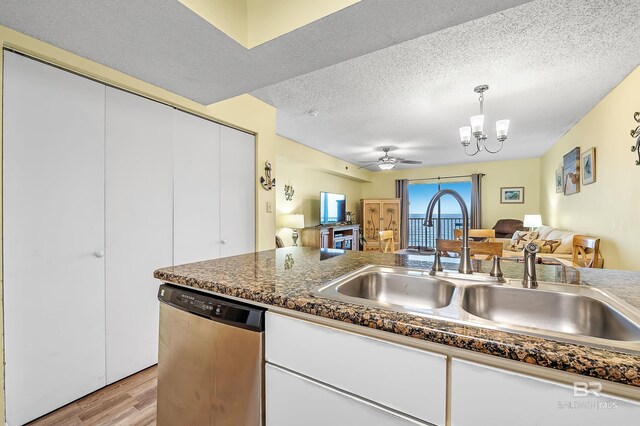 24114 Perdido Beach Blvd Unit 402, Orange Beach, AL 36561 - kitchen with sink, a textured ceiling, white cabinets, stainless steel dishwasher, and light wood-type flooring