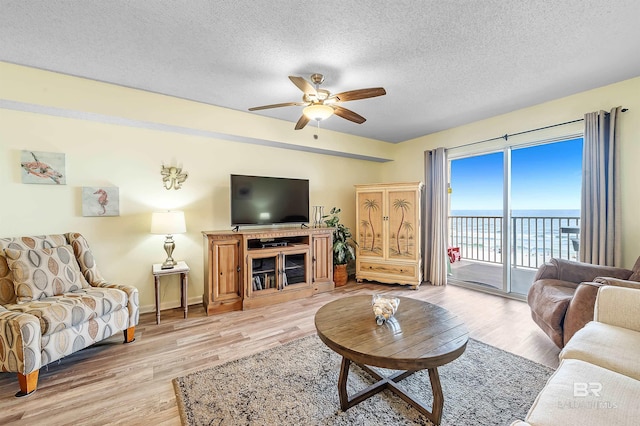 24114 Perdido Beach Blvd Unit 402, Orange Beach, AL 36561 - living room with ceiling fan, a textured ceiling, and light wood-type flooring