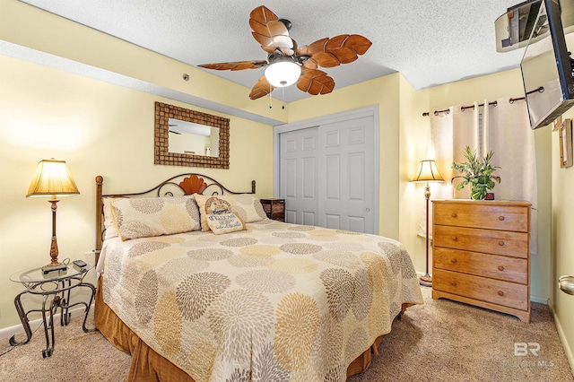 24114 Perdido Beach Blvd Unit 402, Orange Beach, AL 36561 - carpeted bedroom with ceiling fan, a closet, and a textured ceiling