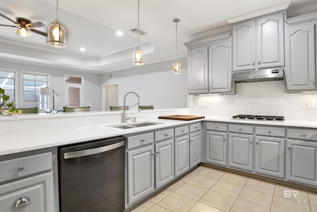 kitchen featuring gray cabinets, a tray ceiling, pendant lighting, and appliances with stainless steel finishes