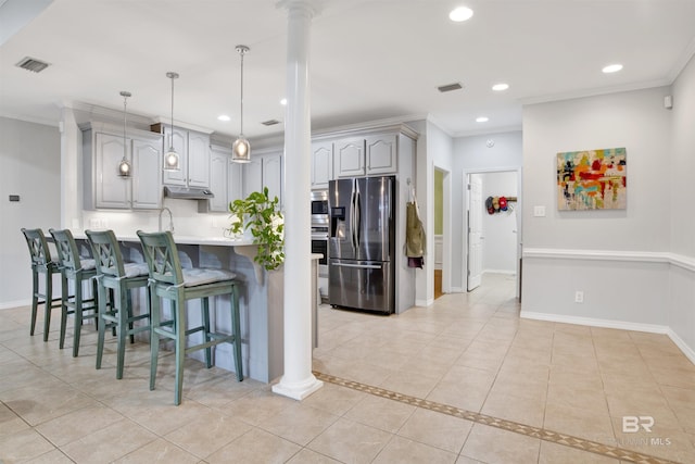 kitchen featuring stainless steel fridge with ice dispenser, decorative columns, gray cabinets, crown molding, and light tile patterned flooring