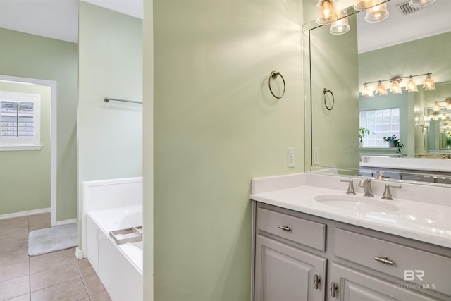 bathroom with vanity, tile patterned flooring, and a bath