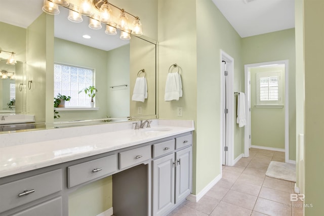 bathroom featuring vanity, tile patterned flooring, and a wealth of natural light