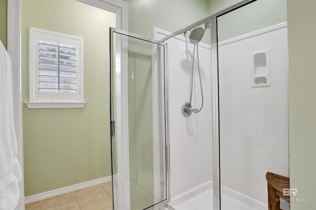 bathroom featuring walk in shower and tile patterned flooring