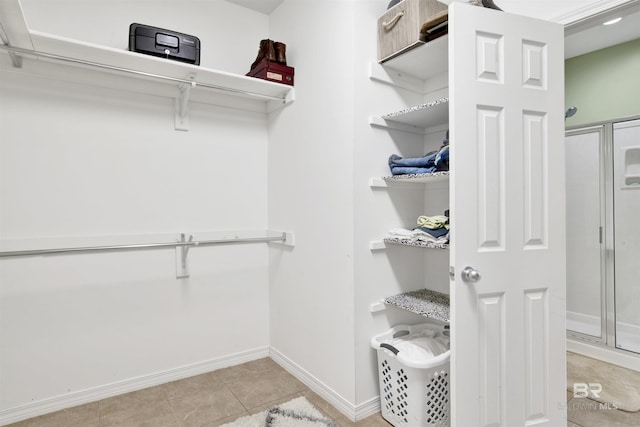 spacious closet with light tile patterned flooring