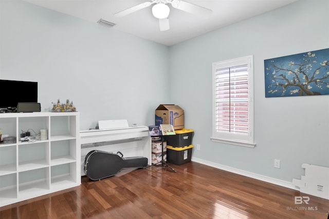 misc room featuring ceiling fan and dark wood-type flooring