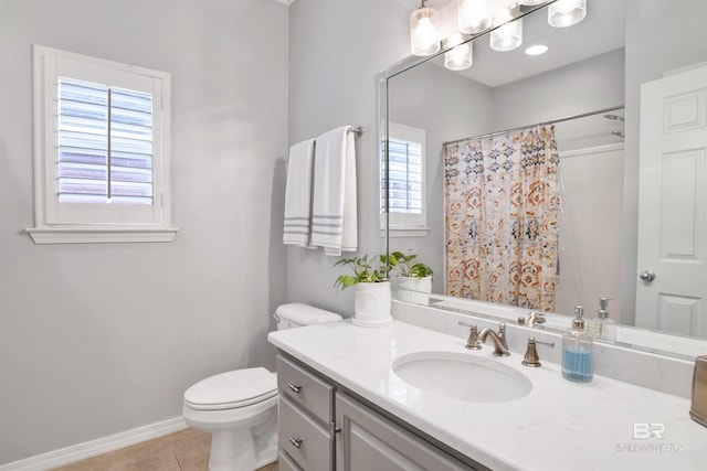 bathroom with toilet, vanity, tile patterned floors, and plenty of natural light