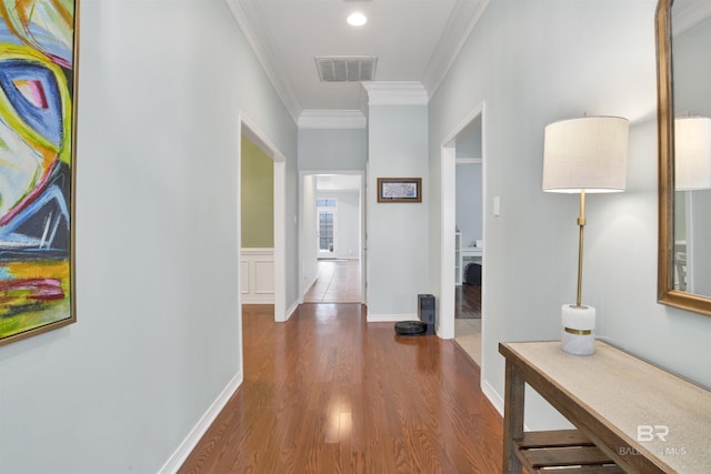 hall with ornamental molding and dark wood-type flooring