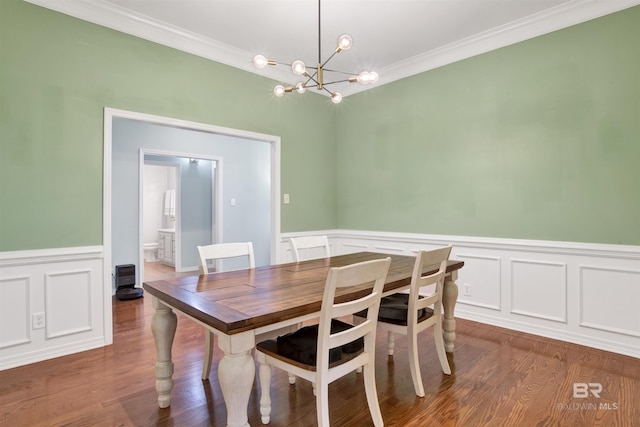 dining space featuring a notable chandelier, crown molding, and dark hardwood / wood-style floors