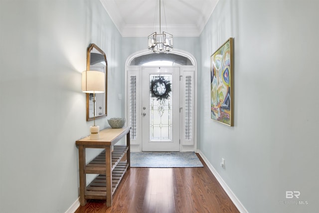 entrance foyer with wood-type flooring, an inviting chandelier, and ornamental molding