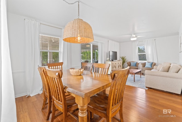 dining space featuring light wood-style flooring and ceiling fan