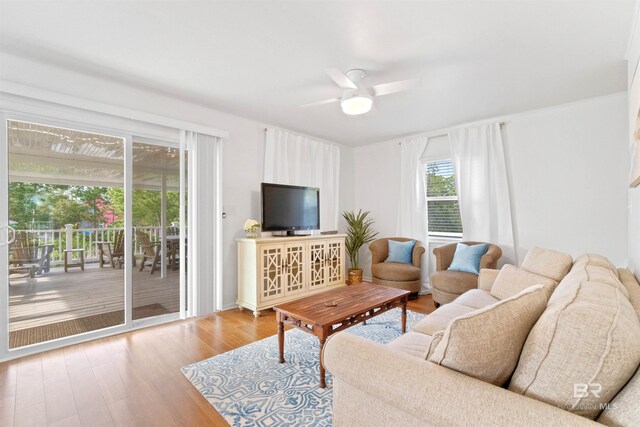 living area with wood finished floors and ceiling fan