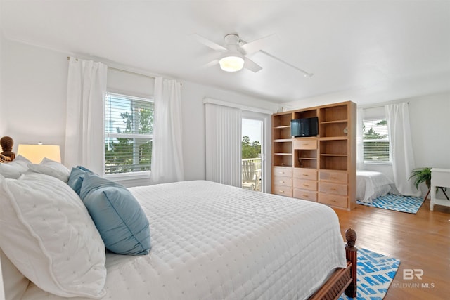 bedroom with a ceiling fan and wood finished floors