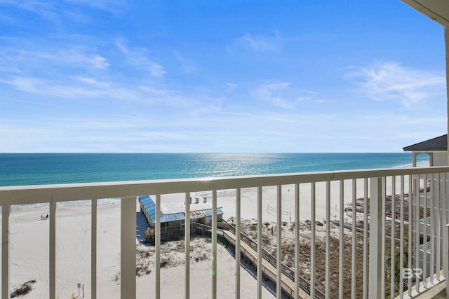 balcony featuring a water view and a beach view