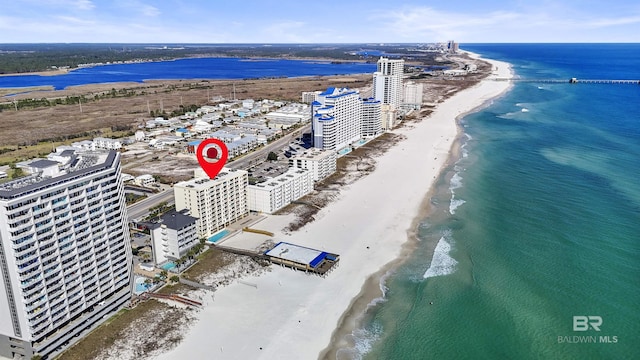 birds eye view of property with a view of city, a beach view, and a water view