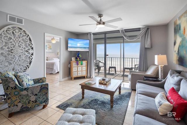 tiled living room with ceiling fan