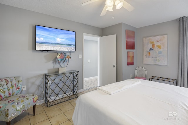 bedroom with light tile patterned floors, a textured ceiling, and ceiling fan