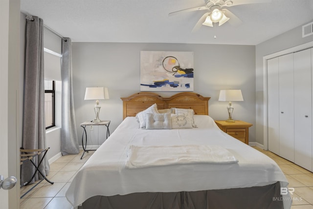 tiled bedroom featuring a textured ceiling, ceiling fan, and a closet