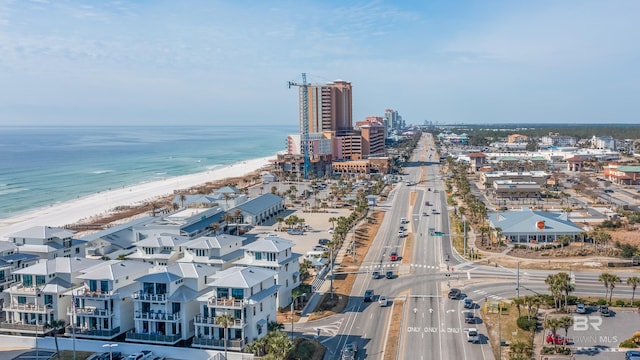 birds eye view of property featuring a beach view and a water view
