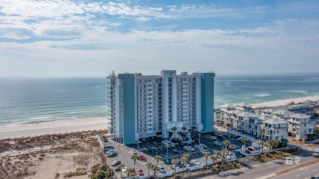 birds eye view of property with a water view and a view of the beach