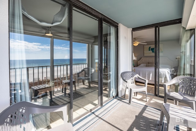 balcony with a beach view and a water view