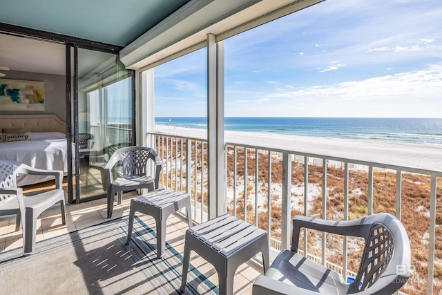 balcony featuring a water view and a view of the beach