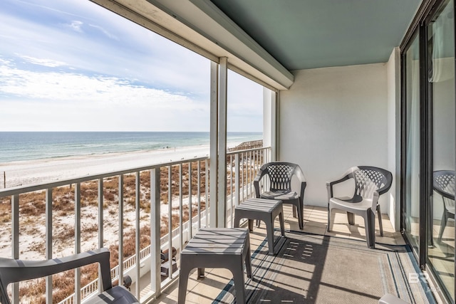 balcony with a beach view and a water view