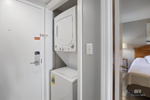 laundry room featuring stacked washer and dryer