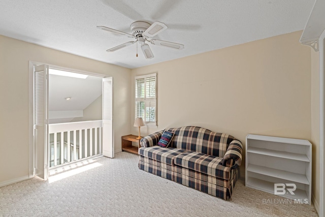 389 Clubhouse Dr Unit 4R, Gulf Shores, AL 36542 - living area featuring carpet floors, ceiling fan, and a textured ceiling