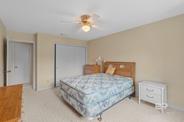 389 Clubhouse Dr Unit 4R, Gulf Shores, AL 36542 - bedroom featuring a closet, light carpet, baseboards, and a ceiling fan