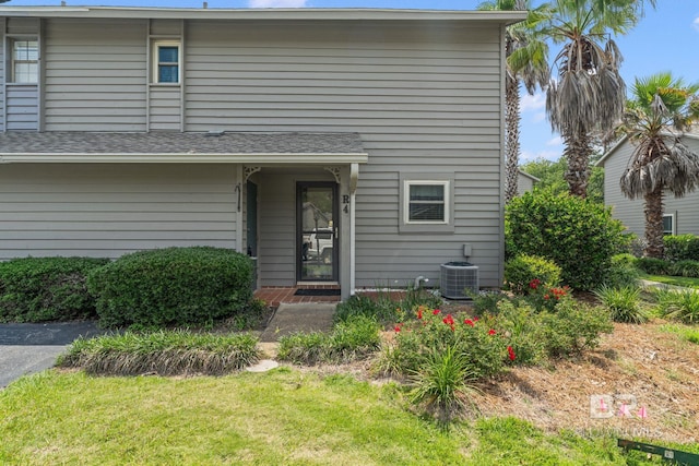 389 Clubhouse Dr Unit 4R, Gulf Shores, AL 36542 - back of house featuring cooling unit and a lawn
