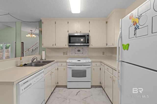 389 Clubhouse Dr Unit 4R, Gulf Shores, AL 36542 - kitchen with white appliances, a sink, light marble finish flooring, light countertops, and a textured ceiling