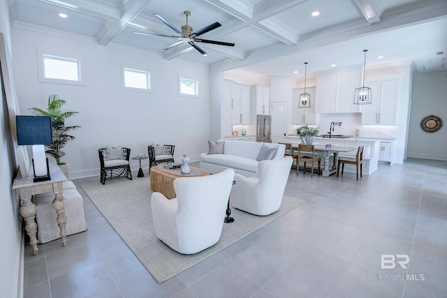 living room featuring beam ceiling, coffered ceiling, and sink