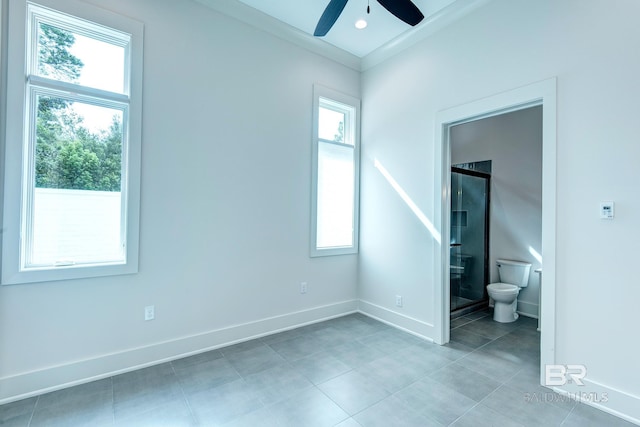 unfurnished bedroom with ceiling fan, ornamental molding, and ensuite bath