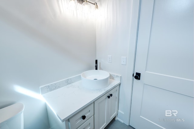 bathroom with toilet and vanity