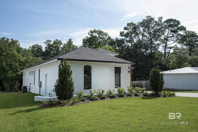 view of front of home with a front yard and cooling unit