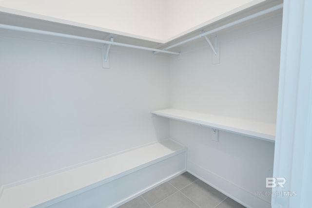 spacious closet featuring light tile patterned floors