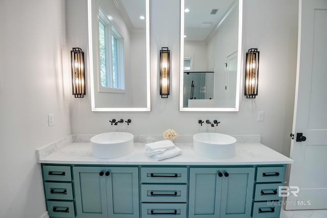 bathroom featuring ornamental molding and vanity