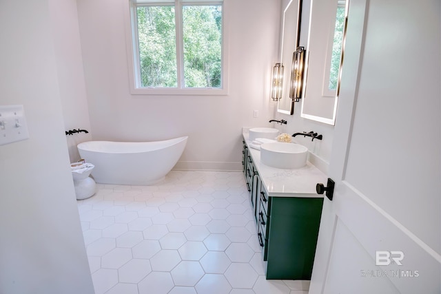 bathroom featuring vanity, tile patterned floors, and a bath