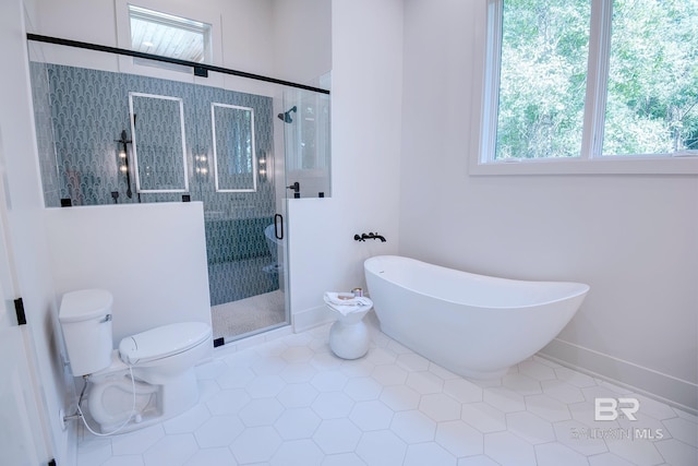 bathroom featuring separate shower and tub, tile patterned flooring, and toilet