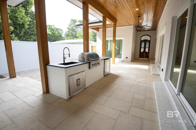 view of patio with exterior kitchen, sink, and area for grilling