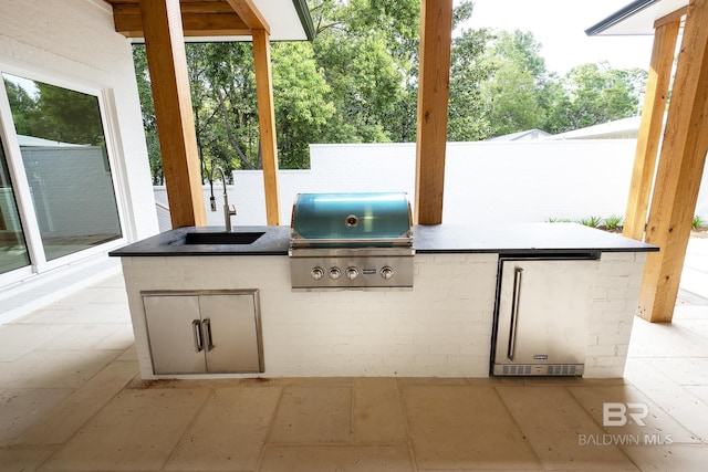 view of patio / terrace with sink, a grill, and area for grilling