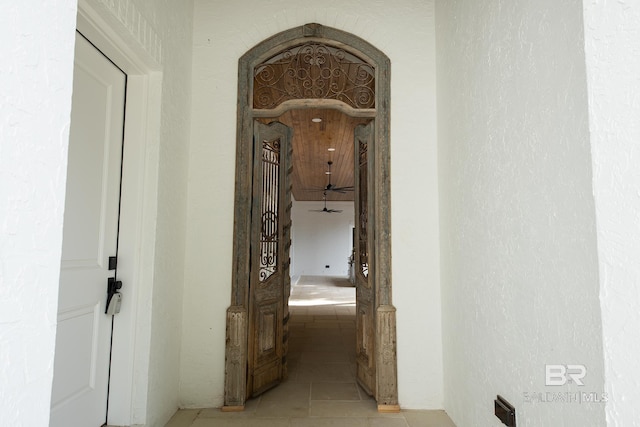 hall featuring light tile patterned flooring